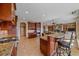 Gourmet kitchen features granite counters, stainless steel appliances, island, and custom cabinets at 1015 Nob Hill Rd, Evergreen, CO 80439