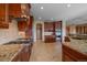 Gourmet kitchen features granite counters, stainless steel appliances, and custom wood cabinets at 1015 Nob Hill Rd, Evergreen, CO 80439
