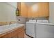 Laundry room with washer, dryer, utility sink, and plenty of cabinet space at 1015 Nob Hill Rd, Evergreen, CO 80439