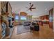 Open-concept living room with stone fireplace, hardwood floors, and stunning mountain views at 1015 Nob Hill Rd, Evergreen, CO 80439