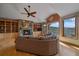 Cozy living room featuring stone fireplace, built-in shelves, and expansive mountain view at 1015 Nob Hill Rd, Evergreen, CO 80439