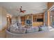 Spacious living area with stone fireplace, built-ins, and mountain views in an open floor plan at 1015 Nob Hill Rd, Evergreen, CO 80439