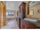 Main bathroom features double vanity, soaking tub, walk-in shower, and mountain view at 1015 Nob Hill Rd, Evergreen, CO 80439