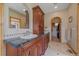 Main bathroom has a double vanity with marble countertops and custom wood cabinets at 1015 Nob Hill Rd, Evergreen, CO 80439
