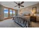 Spacious main bedroom with ceiling fan, balcony access, and scenic mountain views at 1015 Nob Hill Rd, Evergreen, CO 80439