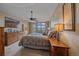 Spacious main bedroom with a ceiling fan, mountain views, and balcony access at 1015 Nob Hill Rd, Evergreen, CO 80439