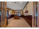Spacious office with wood paneled walls, a comfortable window seat, and natural light at 1015 Nob Hill Rd, Evergreen, CO 80439