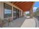 Outdoor patio area with scenic views, stone pillars, and comfortable seating, perfect for relaxation at 1015 Nob Hill Rd, Evergreen, CO 80439