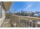 Balcony overlooking a wooded neighborhood with sunny blue skies and a partial view of another home at 4529 Barnacle Ct, Boulder, CO 80301