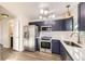 Bright kitchen with stainless steel appliances, white countertops and fashionable navy blue cabinets at 4529 Barnacle Ct, Boulder, CO 80301