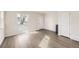 Bright, empty living room featuring wood-look floors, fresh paint, and a door to the outside at 4529 Barnacle Ct, Boulder, CO 80301