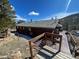 Cabin featuring a wood deck and lush surroundings, perfect for peaceful living at 11798 Sidney Rd, Golden, CO 80403