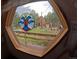 Charming view through a window with a decorative stained glass, overlooking the verdant exterior at 11798 Sidney Rd, Golden, CO 80403