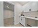 Pantry offers ample storage with white cabinetry, sleek black hardware, and open doorway to a carpeted room at 2430 Ames St, Edgewater, CO 80214