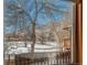 View of backyard through window, snow on ground at 810 Meadow Run, Golden, CO 80403