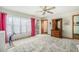 Bright bedroom with large windows, a ceiling fan, and ample closet space at 810 Meadow Run, Golden, CO 80403