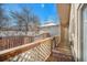 Back deck with wooden railing and backyard view at 810 Meadow Run, Golden, CO 80403