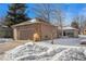 House exterior with a two-car garage and snow-covered front yard at 810 Meadow Run, Golden, CO 80403