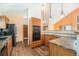 Kitchen with granite countertops, wooden cabinets, and modern appliances at 810 Meadow Run, Golden, CO 80403