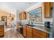 Well-equipped kitchen featuring granite countertops and wooden cabinetry at 810 Meadow Run, Golden, CO 80403