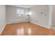 Empty bedroom featuring wood-look floors, neutral colored walls and shuttered window at 7218 S Iris Ct, Littleton, CO 80128