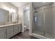 This bathroom offers dual sinks, granite countertops, and walk-in shower at 2648 Mayotte Way, Castle Rock, CO 80109