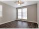 This bedroom offers wood floors, white baseboards, and a large window at 2648 Mayotte Way, Castle Rock, CO 80109