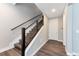 Bright foyer featuring hardwood floors, a modern staircase with metal accents, and access to the main floor at 2648 Mayotte Way, Castle Rock, CO 80109
