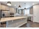 Stylish kitchen boasts stainless steel appliances, a large island, pendant lighting, and plenty of counter space at 2648 Mayotte Way, Castle Rock, CO 80109