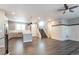 Spacious and bright living area adjacent to the kitchen featuring modern wood floors and contemporary finishes at 2648 Mayotte Way, Castle Rock, CO 80109