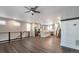Open-concept living space with wood floors, modern lighting, staircase, and seamless flow into the kitchen at 2648 Mayotte Way, Castle Rock, CO 80109