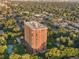 Aerial view of a high rise building with tennis courts and a pool at 1900 E Girard Pl # 608, Englewood, CO 80113