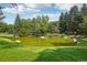 Serene pond with lush landscaping and trees at 1900 E Girard Pl # 608, Englewood, CO 80113