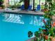 Indoor swimming pool with lounge chairs, lush plants, and natural light from a glass ceiling at 1900 E Girard Pl # 608, Englewood, CO 80113