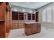 Spacious walk-in closet with custom wood shelving and an island with granite countertops at 4749 Starfire Cir, Castle Rock, CO 80104