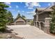 Wide driveway leading to a home with multiple garage spaces, plus beautiful mountain views in the distance at 4749 Starfire Cir, Castle Rock, CO 80104