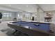 Recreational space features a pool table, seating area, bar with stools, foosball table, and ample room for entertaining and relaxation at 4749 Starfire Cir, Castle Rock, CO 80104