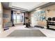 Home gym with an exercise bike, weights, TV, mirrored wall, and a wall of contemporary paintings for a complete fitness space at 4749 Starfire Cir, Castle Rock, CO 80104