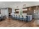 Open concept kitchen with a center island, stainless steel appliances, and custom wood cabinetry at 4749 Starfire Cir, Castle Rock, CO 80104