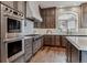 Modern kitchen features stainless steel appliances, wood cabinets, and a large arched window at 4749 Starfire Cir, Castle Rock, CO 80104