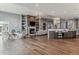 Spacious living room with a stone fireplace, built-in shelves, and hardwood floors at 4749 Starfire Cir, Castle Rock, CO 80104