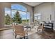 Stunning living room featuring an over-sized picture window with views of nature and elegant seating at 4749 Starfire Cir, Castle Rock, CO 80104