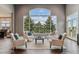 Stunning living room featuring an over-sized picture window with views of nature and elegant seating at 4749 Starfire Cir, Castle Rock, CO 80104