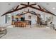 Open-concept living area with vaulted ceilings, wood beams, kitchen island, and dining area at 4749 Starfire Cir, Castle Rock, CO 80104