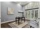 Bright home office with ample natural light from a large arched window and comfortable seating at 4749 Starfire Cir, Castle Rock, CO 80104