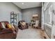 Cozy sitting room with comfortable leather armchairs and a decorative bookshelf at 4749 Starfire Cir, Castle Rock, CO 80104