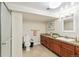 Bathroom featuring a tile floor, wooden vanity with drawers, and a framed mirror at 3055 N Albion St, Denver, CO 80207