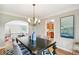 Elegant dining room with chandelier and view into kitchen at 3055 N Albion St, Denver, CO 80207