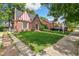 Charming brick home with well-maintained lawn, walkway, and professional real estate sign at 3055 N Albion St, Denver, CO 80207