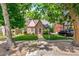 Charming brick Tudor-style home with well-manicured lawn and mature trees at 3055 N Albion St, Denver, CO 80207